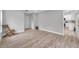 Spacious bedroom with wood-look floors and a view of the kitchen at 2643 Narcissus Dr, Holiday, FL 34691
