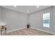 Well-lit bedroom with wood-look floors and pool view at 2643 Narcissus Dr, Holiday, FL 34691