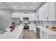 Modern kitchen with white cabinets, stainless steel appliances, and quartz countertops at 2643 Narcissus Dr, Holiday, FL 34691