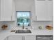 Kitchen features white cabinets and quartz countertops at 2643 Narcissus Dr, Holiday, FL 34691