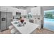 Modern kitchen with island, stainless steel appliances, and pool view at 2643 Narcissus Dr, Holiday, FL 34691