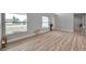 Bright living room featuring wood-look flooring and large windows at 2643 Narcissus Dr, Holiday, FL 34691