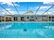 Refreshing pool with covered patio, ready for summer fun at 2643 Narcissus Dr, Holiday, FL 34691