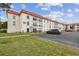 Condo building exterior with parking and landscaping at 2700 Bayshore Blvd # 3108, Dunedin, FL 34698