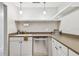Modern kitchen with white cabinets and stainless steel appliances at 2700 Bayshore Blvd # 3108, Dunedin, FL 34698