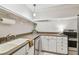 Updated kitchen with white cabinets and stainless steel appliances at 2700 Bayshore Blvd # 3108, Dunedin, FL 34698
