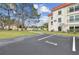 Condo building parking lot with marked spaces at 2700 Bayshore Blvd # 3108, Dunedin, FL 34698