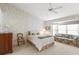 Bedroom with a bed, sitting area, and large window at 3053 Appleblossom Trl, Spring Hill, FL 34606