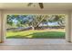 Spacious patio overlooking a lush, tree-lined backyard at 3053 Appleblossom Trl, Spring Hill, FL 34606