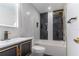 Modern bathroom with marble tile and gold fixtures at 405 Pine S Ave, Oldsmar, FL 34677