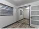 Bright bedroom featuring wood-look floors and mirrored closet doors at 405 Pine S Ave, Oldsmar, FL 34677
