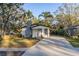 Newly renovated home with a modern exterior and landscaped front yard at 405 Pine S Ave, Oldsmar, FL 34677