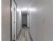 Clean hallway with light grey walls and wood-look flooring at 405 Pine S Ave, Oldsmar, FL 34677