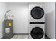 Laundry room with new LG stackable washer and dryer and hot water heater at 405 Pine S Ave, Oldsmar, FL 34677