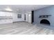 Open concept living room with fireplace and modern flooring at 405 Pine S Ave, Oldsmar, FL 34677