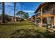 Back view of community with grassy lawn and screened lanais at 4426 Pelorus Dr # 4426, New Port Richey, FL 34652
