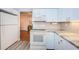 White kitchen features granite countertops and stainless steel appliances at 4426 Pelorus Dr # 4426, New Port Richey, FL 34652