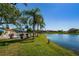Scenic lakefront view with lush landscaping and condo buildings at 4426 Pelorus Dr # 4426, New Port Richey, FL 34652
