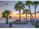 Scenic beach at sunset with palm trees and seating at 4515 Marine Pkwy # 102, New Port Richey, FL 34652