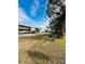 Condo building with parking lot and mature trees at 4515 Marine Pkwy # 102, New Port Richey, FL 34652