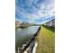 Canal-front property with lush grass and beautiful sky at 4515 Marine Pkwy # 102, New Port Richey, FL 34652