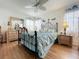 Relaxing bedroom with light blue bedding and ceiling fan at 4912 Enfield Ct, New Port Richey, FL 34655