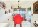Cozy dining area with red table and chairs at 4912 Enfield Ct, New Port Richey, FL 34655