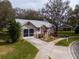 Charming single story home with grey roof and lush landscaping at 4912 Enfield Ct, New Port Richey, FL 34655