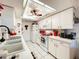Clean kitchen with white cabinets, modern appliances, and a breakfast bar at 4912 Enfield Ct, New Port Richey, FL 34655