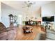 Spacious living room featuring hardwood floors, comfy seating, and a large TV at 4912 Enfield Ct, New Port Richey, FL 34655