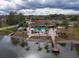 Community pool with clubhouse, landscaping, and lake access at 4912 Enfield Ct, New Port Richey, FL 34655