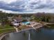 Community pool area with clubhouse and lake view at 4912 Enfield Ct, New Port Richey, FL 34655