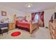 Spacious bedroom with a wooden bed frame and red bedding at 5182 Colchester Ave, Spring Hill, FL 34608