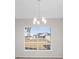 Bright dining room with large window and chandelier, offering backyard view at 5948 Lyon Rd, Spring Hill, FL 34606