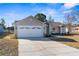 Two-car garage and landscaped yard at 5948 Lyon Rd, Spring Hill, FL 34606