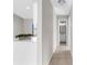 Clean hallway with tile flooring and half bathroom at 5948 Lyon Rd, Spring Hill, FL 34606