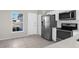 Modern kitchen features stainless steel appliances and white cabinets at 5948 Lyon Rd, Spring Hill, FL 34606