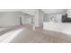 Bright living room with tile and carpet flooring, and view into kitchen at 5948 Lyon Rd, Spring Hill, FL 34606