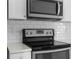 Stainless steel microwave installed above the stove at 5948 Lyon Rd, Spring Hill, FL 34606