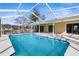 Inviting swimming pool with a screened enclosure at 5948 Lyon Rd, Spring Hill, FL 34606