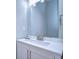 Modern bathroom with white vanity and large mirror at 6417 River Rd, New Port Richey, FL 34652