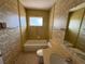 Clean bathroom with a shower/tub combo and vintage wallpaper at 705 Churchill Pl, Sun City Center, FL 33573