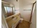 Clean bathroom with single sink vanity, toilet, and shower at 705 Churchill Pl, Sun City Center, FL 33573