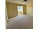 Spacious bedroom with large window and neutral carpet at 705 Churchill Pl, Sun City Center, FL 33573