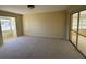 Bright bedroom with sliding glass doors to balcony at 705 Churchill Pl, Sun City Center, FL 33573