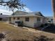 Single story house exterior with gray roof and partial landscaping at 705 Churchill Pl, Sun City Center, FL 33573