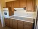 View of kitchen's cooking area with wood cabinets and countertop at 705 Churchill Pl, Sun City Center, FL 33573
