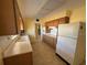 Well-lit kitchen with wood cabinets, stove, and a refrigerator at 705 Churchill Pl, Sun City Center, FL 33573