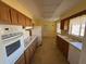 Long kitchen with ample counter space, cabinets, and appliances at 705 Churchill Pl, Sun City Center, FL 33573