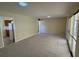 Open living room with view of kitchen and access to sunroom at 705 Churchill Pl, Sun City Center, FL 33573